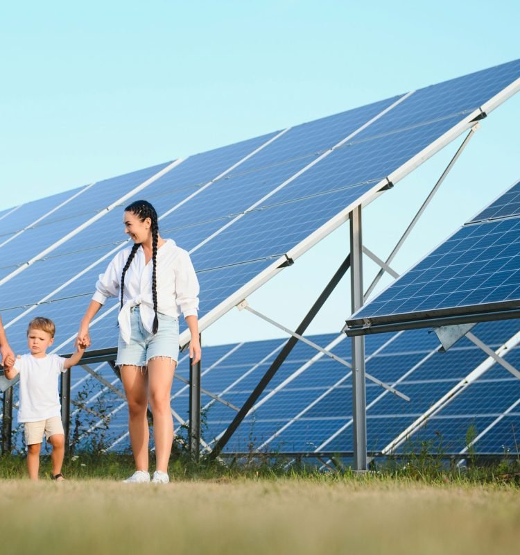 Happy family near solar panels. Alternative energy source.
